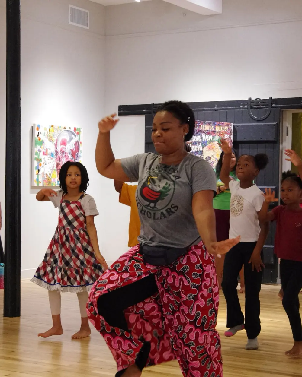 A Sankofa Scholars volunteer helping students with a cultural learning activity